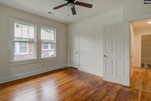 unfurnished bedroom featuring ceiling fan and hardwood / wood-style flooring