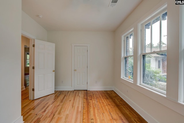 unfurnished room featuring light hardwood / wood-style floors