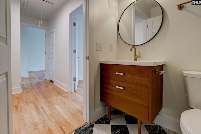 bathroom featuring vanity and toilet