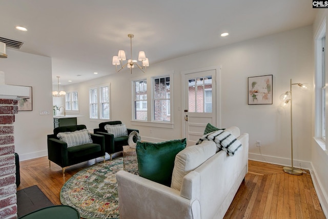 living room featuring a chandelier, light hardwood / wood-style flooring, and sink