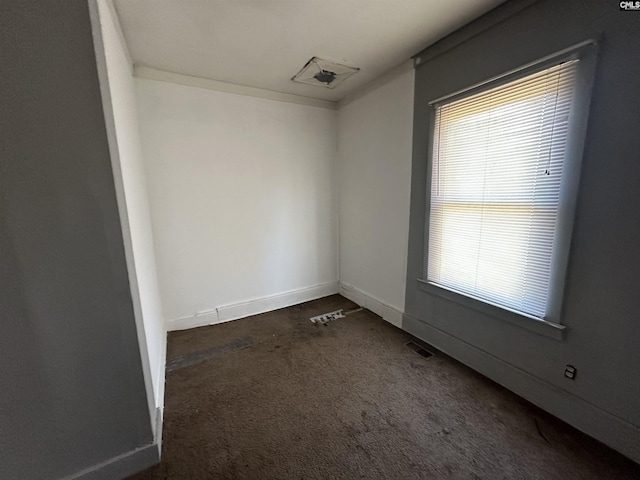 empty room with dark carpet