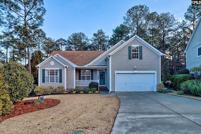 view of property featuring covered porch and a garage