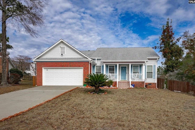 ranch-style home featuring a front lawn, covered porch, and a garage