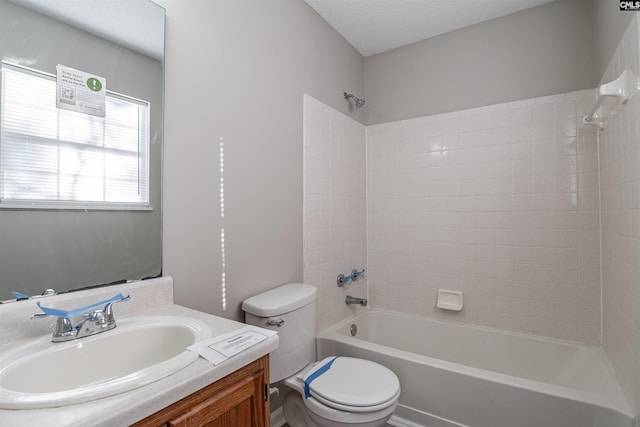 full bathroom with a textured ceiling, vanity, toilet, and tub / shower combination