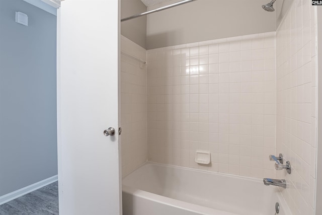 bathroom featuring shower / bathing tub combination and hardwood / wood-style flooring