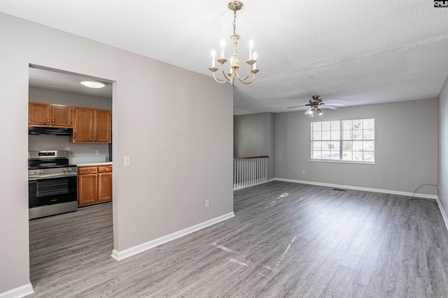 interior space featuring ceiling fan with notable chandelier, a textured ceiling, and hardwood / wood-style flooring