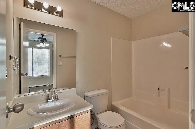 full bathroom with tub / shower combination, vanity, a textured ceiling, ceiling fan, and toilet