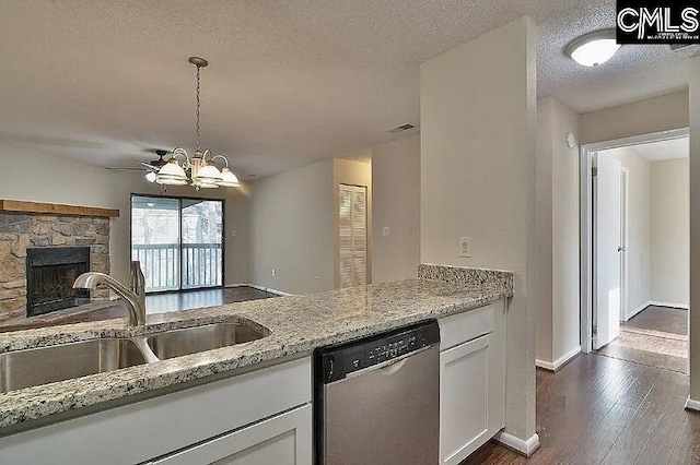 kitchen featuring dishwasher, white cabinets, sink, a textured ceiling, and light stone counters