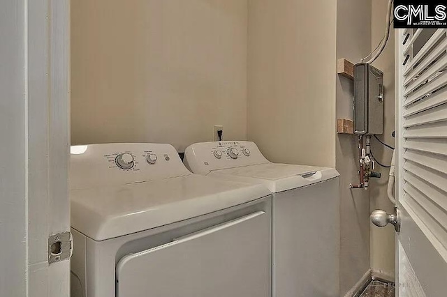 clothes washing area featuring separate washer and dryer