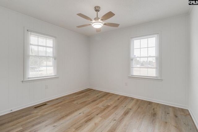 spare room featuring ceiling fan and light hardwood / wood-style floors