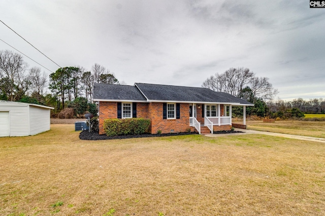 ranch-style house with a front lawn, an outbuilding, central AC unit, a porch, and a garage