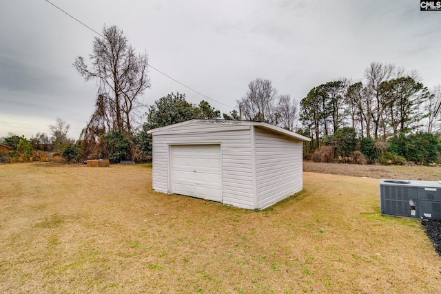 garage with central AC and a yard