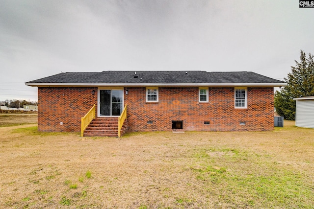 rear view of property with a lawn and cooling unit