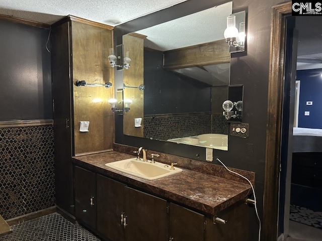 bathroom with vanity, tile patterned floors, and a textured ceiling