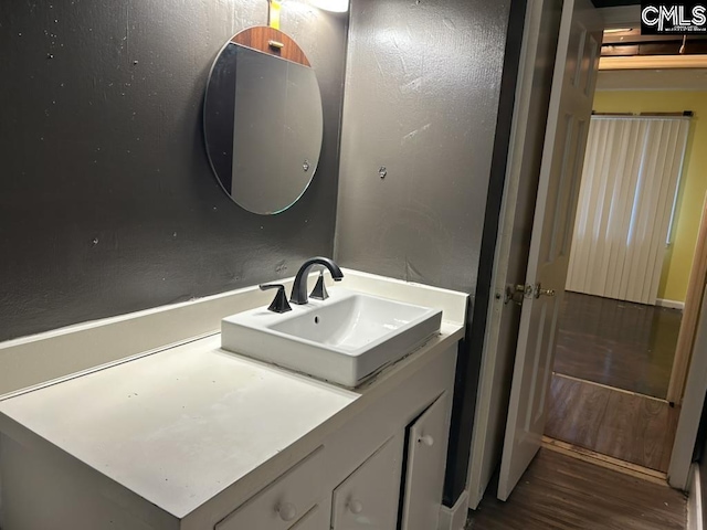 bathroom with vanity and hardwood / wood-style flooring