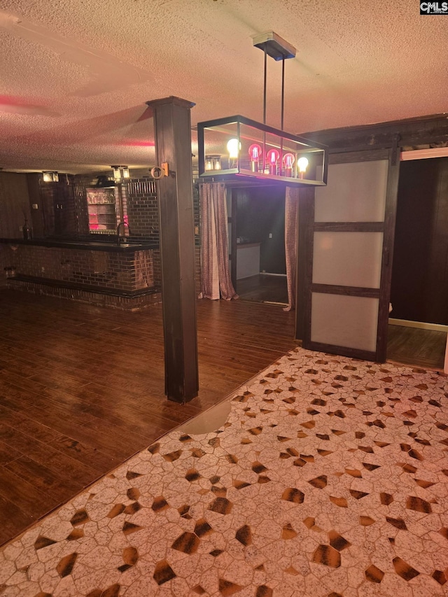 interior space with dark wood-type flooring and a textured ceiling