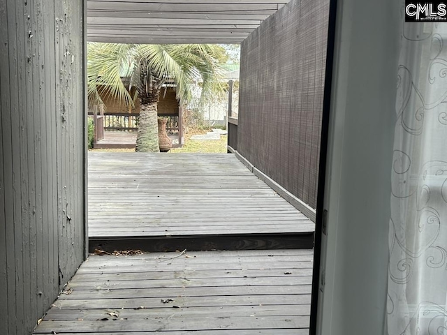 doorway to outside with wood walls