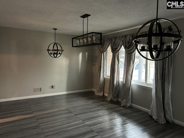 unfurnished dining area with a textured ceiling