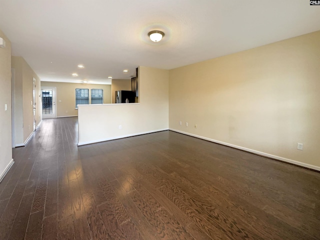 unfurnished living room with dark hardwood / wood-style flooring