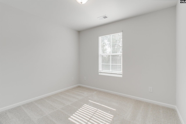 unfurnished room featuring light carpet