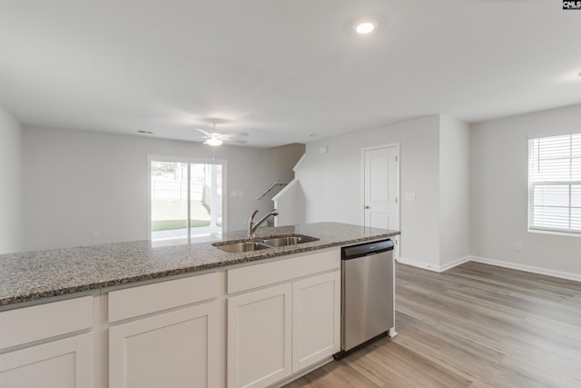 kitchen with ceiling fan, sink, light stone counters, stainless steel dishwasher, and white cabinets