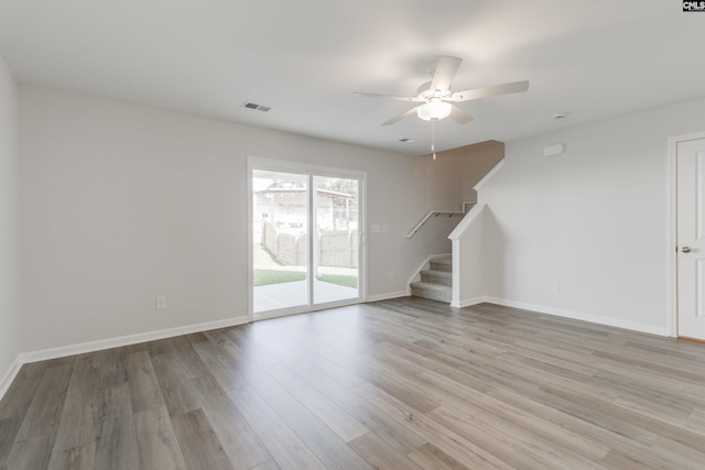 unfurnished living room featuring ceiling fan and light wood-type flooring