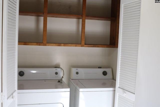 washroom with cabinets and washing machine and dryer