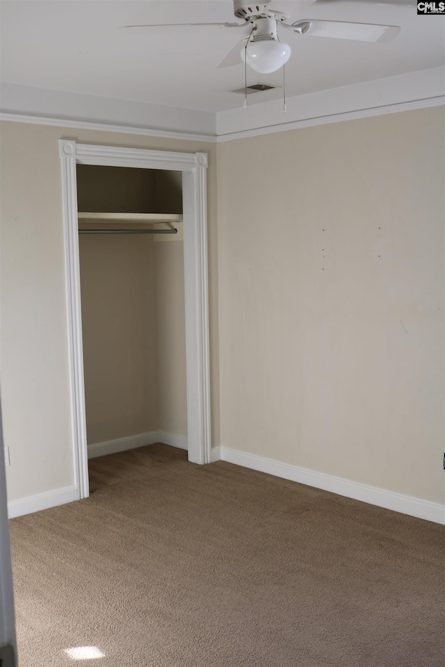 unfurnished bedroom with ceiling fan, a closet, and carpet