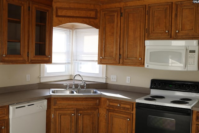 kitchen featuring white appliances and sink