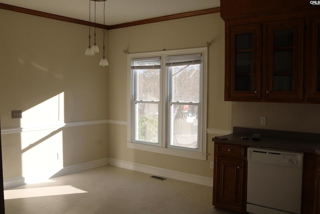 kitchen with white dishwasher, crown molding, a healthy amount of sunlight, and hanging light fixtures