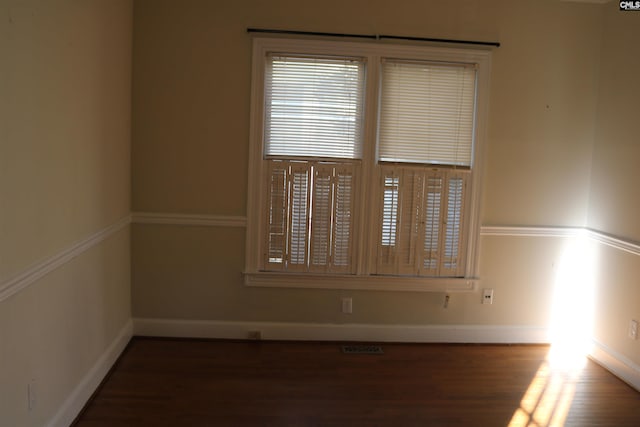 empty room with dark hardwood / wood-style floors