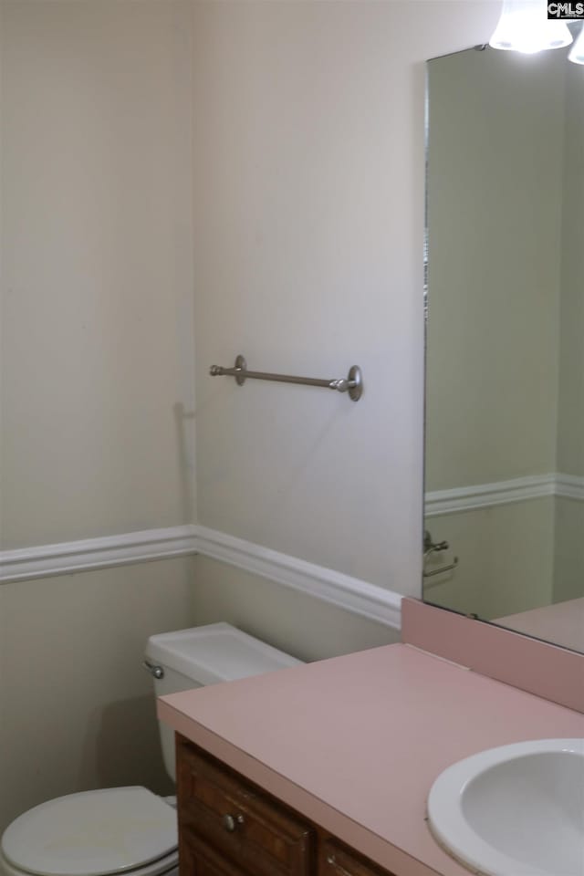 bathroom featuring toilet and vanity