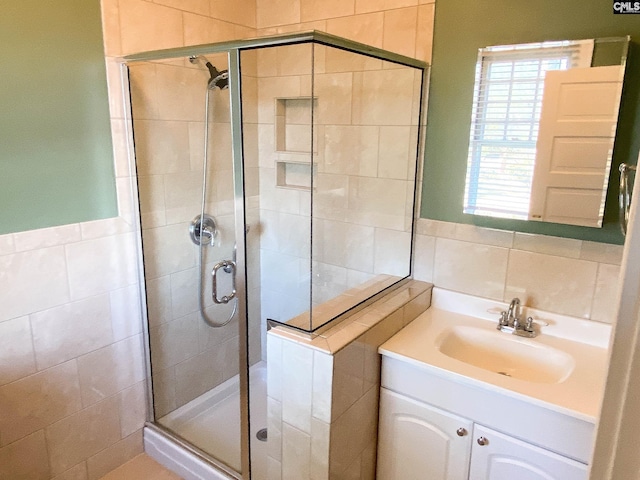 bathroom with vanity, an enclosed shower, and decorative backsplash