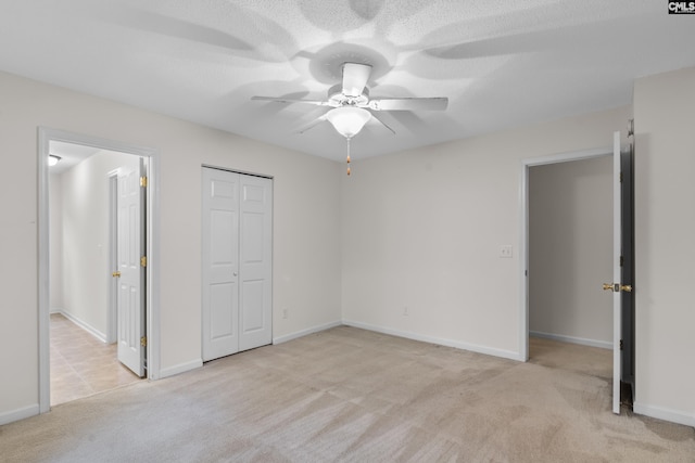 unfurnished bedroom featuring ceiling fan and light carpet