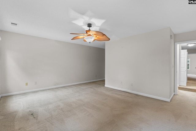 empty room featuring light carpet and ceiling fan