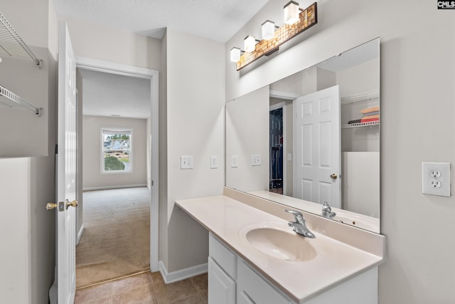 bathroom featuring tile patterned flooring, a textured ceiling, and vanity