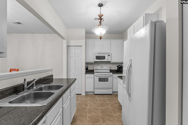 kitchen featuring white appliances, decorative light fixtures, white cabinetry, and sink