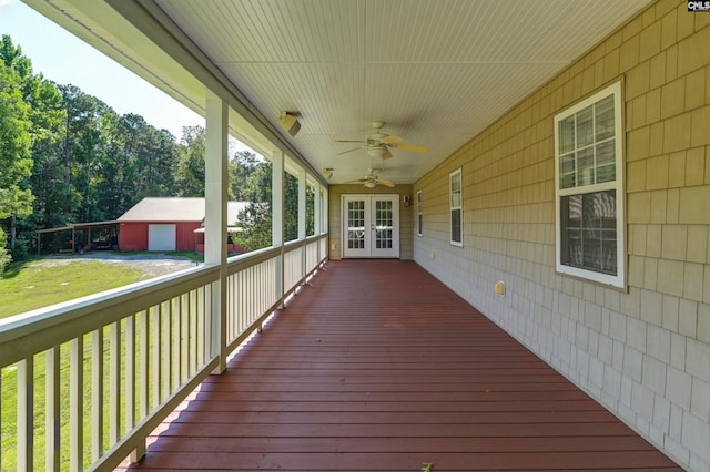 deck featuring french doors, a garage, and ceiling fan