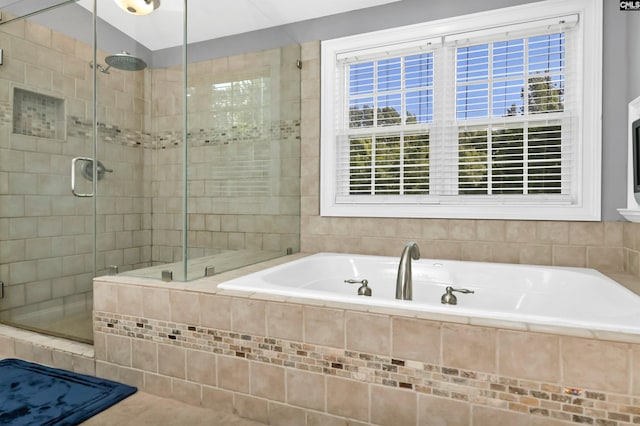 bathroom featuring shower with separate bathtub