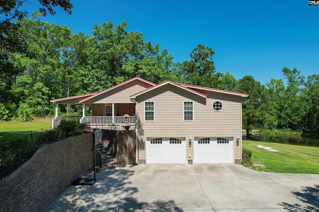 view of front of home with a porch, a garage, and a front yard