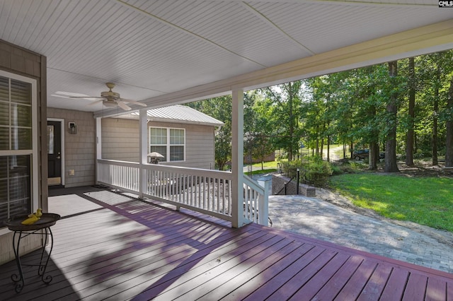 wooden deck with a yard and ceiling fan