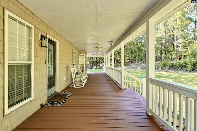 wooden terrace featuring ceiling fan and a porch