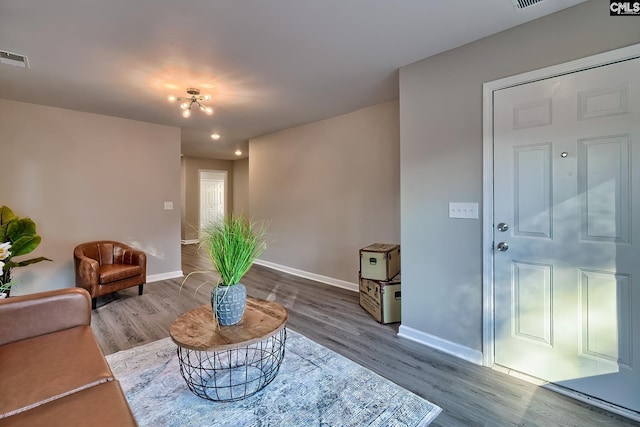 sitting room with wood-type flooring