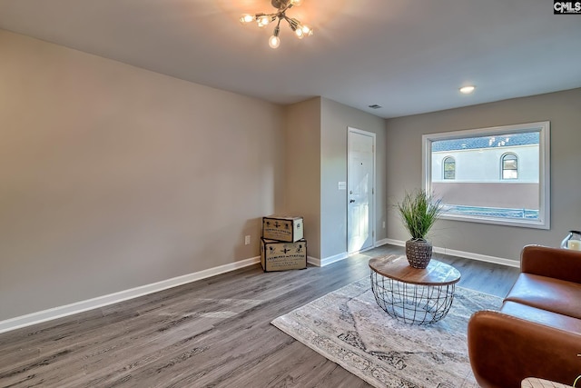 sitting room featuring hardwood / wood-style floors and a notable chandelier