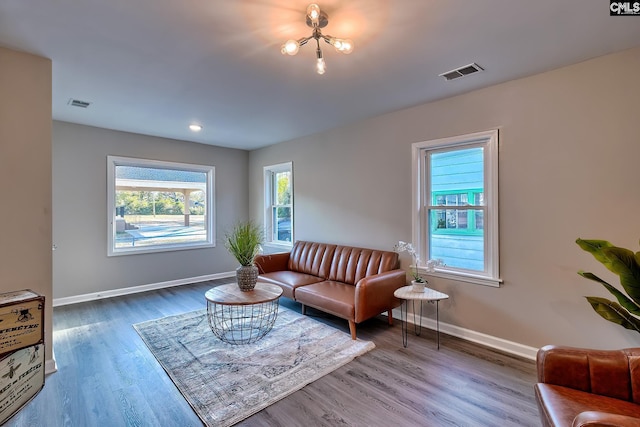 living room with hardwood / wood-style floors and a chandelier