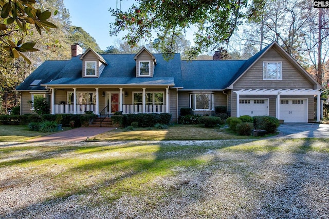 cape cod house with covered porch, a garage, and a front lawn