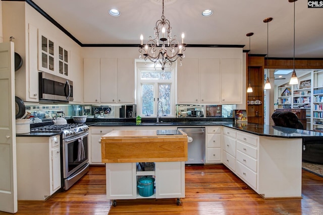 kitchen featuring white cabinetry, a center island, and stainless steel appliances