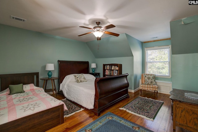 bedroom with ceiling fan, dark hardwood / wood-style floors, and vaulted ceiling