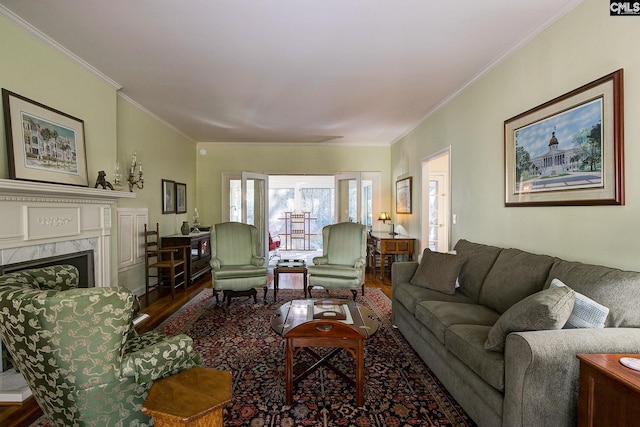 living room featuring a fireplace, ornamental molding, and hardwood / wood-style flooring