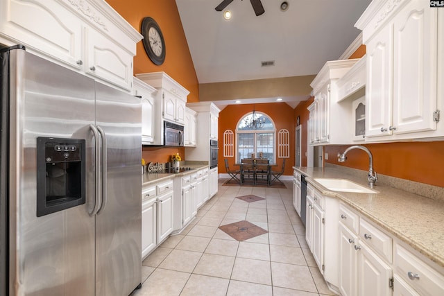 kitchen with appliances with stainless steel finishes, ceiling fan, sink, light tile patterned floors, and white cabinets